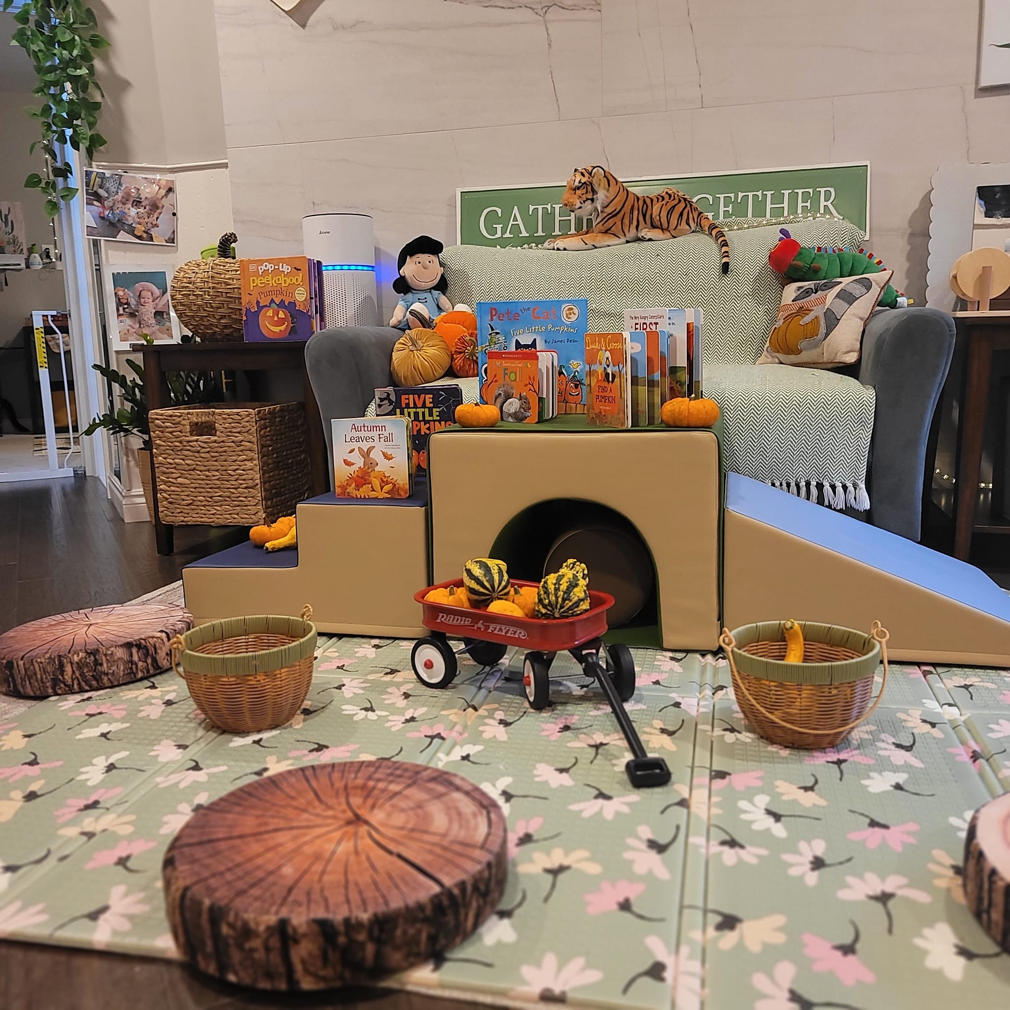 Autumn provocation display with pumpkins, books, baskets, and natural materials