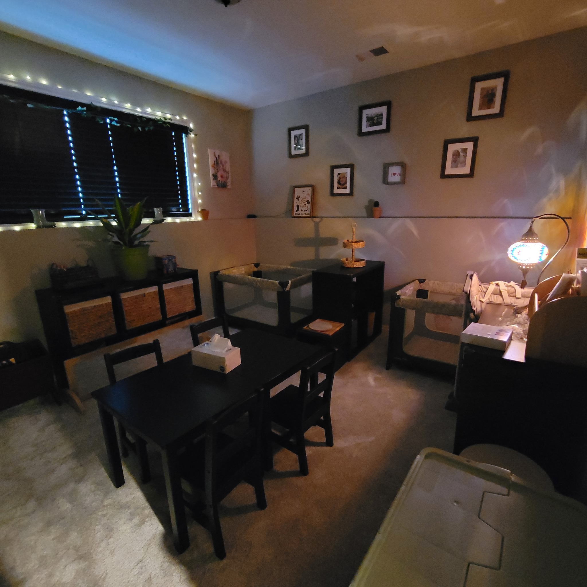 Nap room with cribs, fairy lights, and Turkish lamp