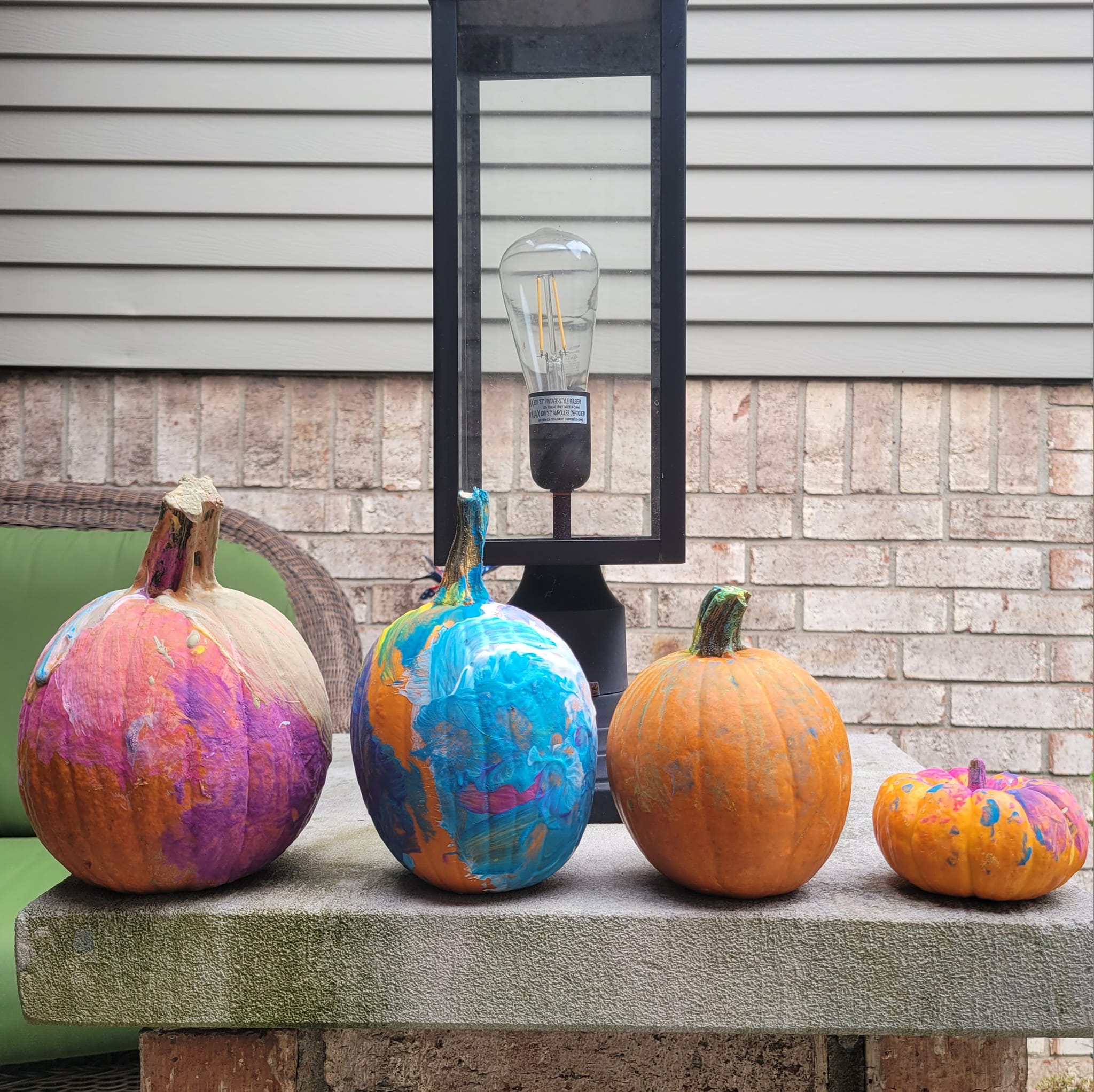 Colourful painted pumpkins displayed on the porch