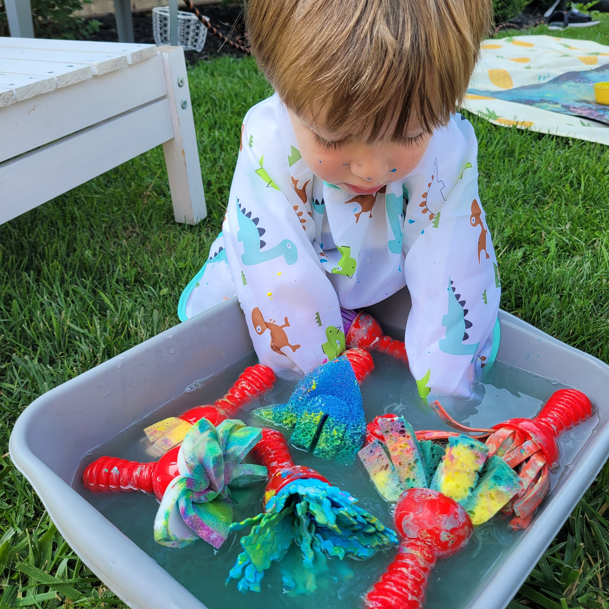 Child exploring a water sensory bin